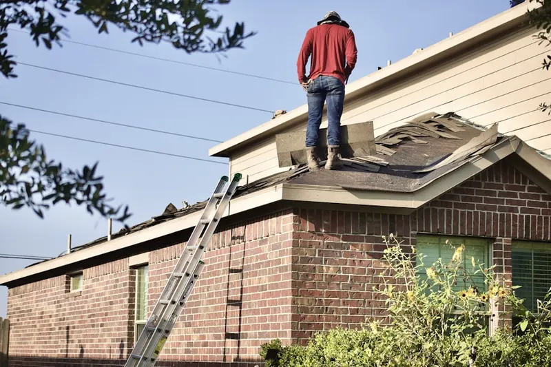 Professional roofer working on a residential roof in Bethany Crossroads